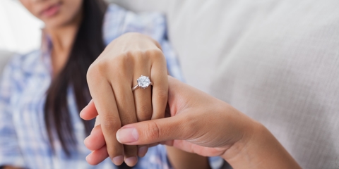 Engagement ring holding hands